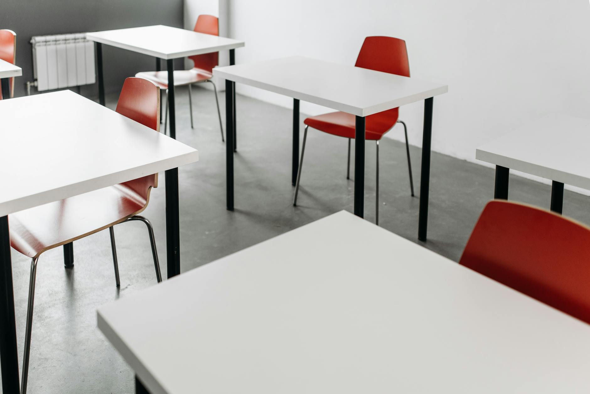 close up photo of desks and chairs inside the classroom